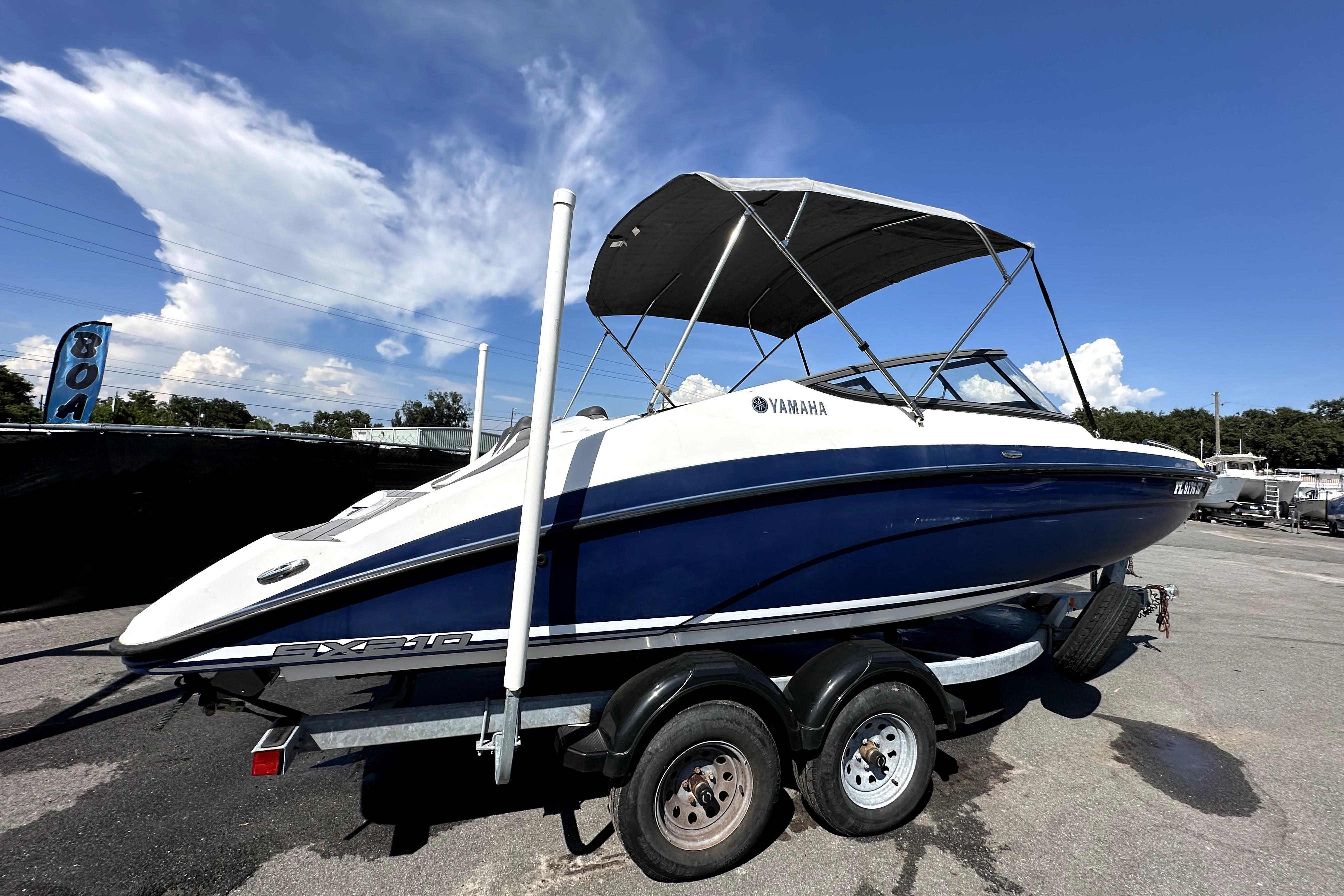Yamaha Boats SX210 2020 Yamaha Boats SX210 on trailer under clear blue sky.