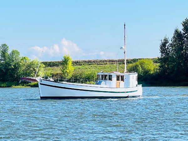 Colin Archer 42 1955 Colin Archer 42 boat sailing on a calm river.