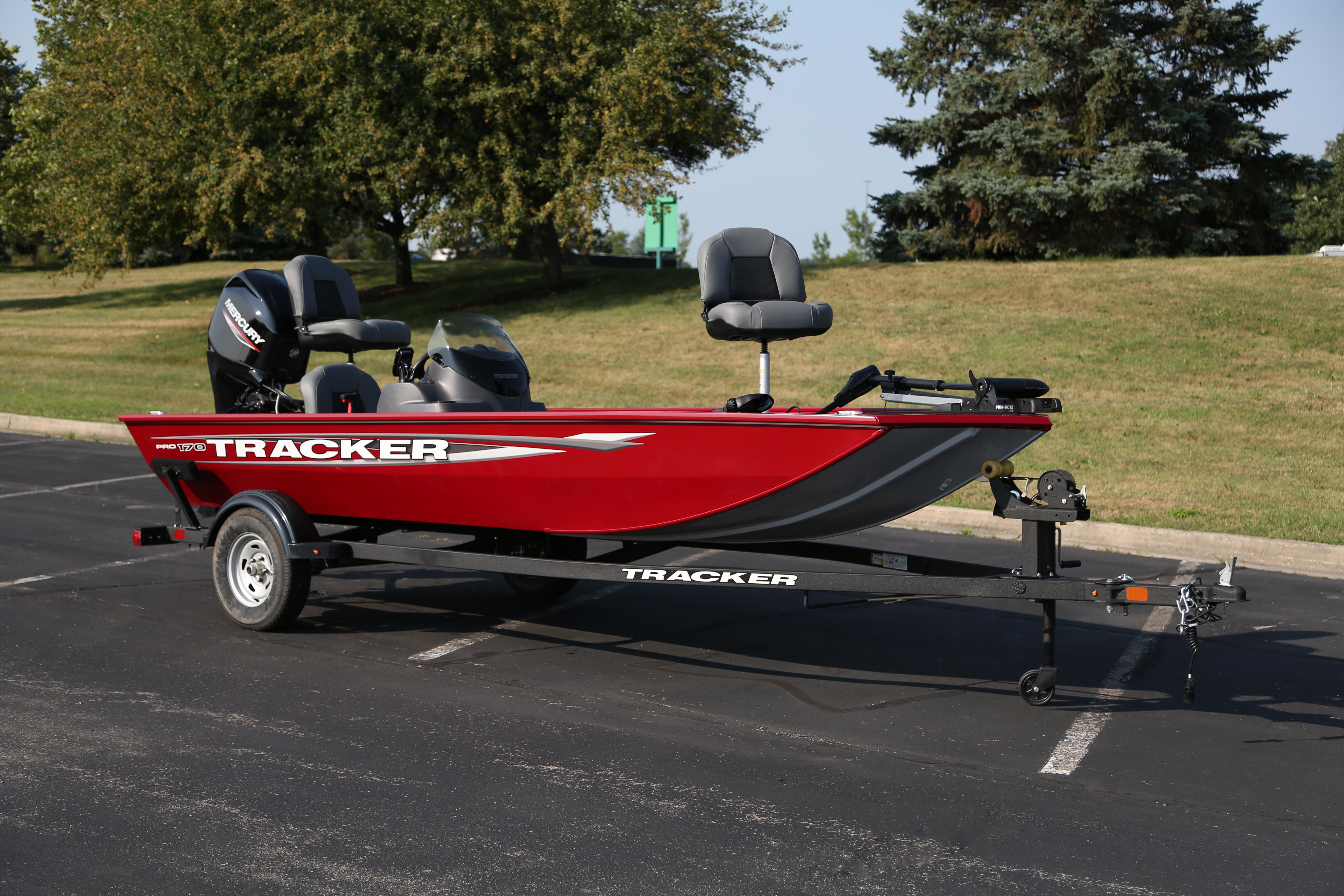 Tracker Pro 170 2025 Tracker Pro 170 boat on trailer, parked outdoors, with red and black design.
