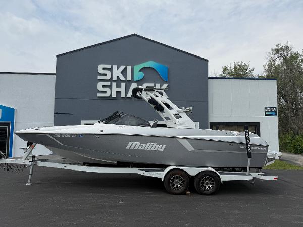 Malibu Wakesetter 24 MXZ 2020 Malibu Wakesetter 24 MXZ boat on trailer outside Ski Shack building.