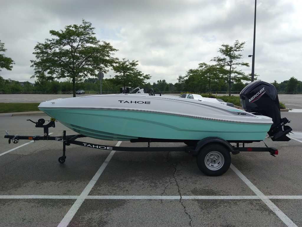 Tahoe T16 2026 Tahoe T16 boat on trailer in parking lot, overcast sky.