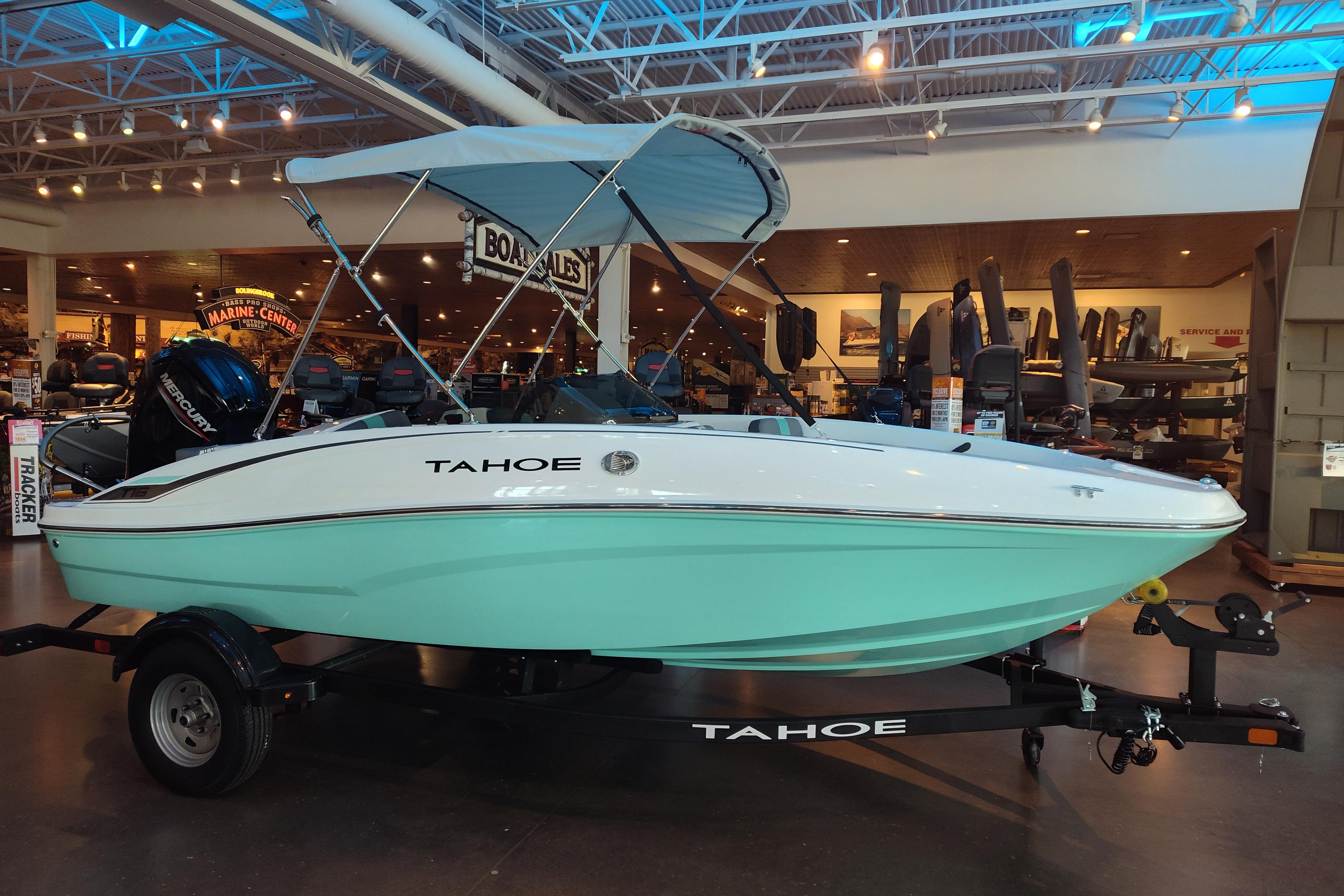 Tahoe T16 2026 Tahoe T16 boat with canopy on display in a showroom.
