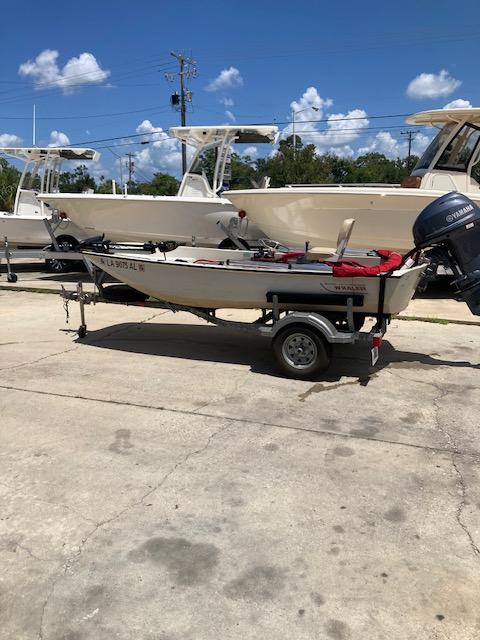 Boston Whaler 13 1980 Boston Whaler 13 boat on trailer, parked outdoors under a clear blue sky.