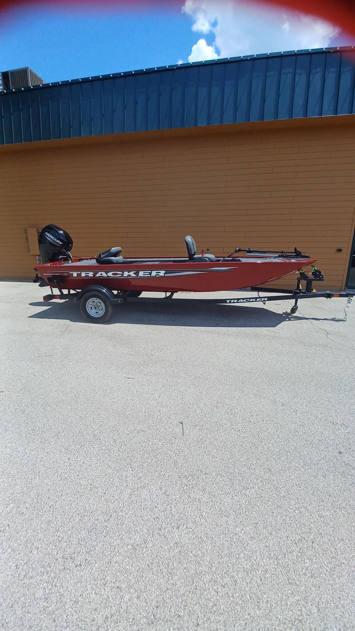 Tracker Panfish 17 2025 Tracker Panfish 17 boat on trailer, parked outdoors against a yellow wall.