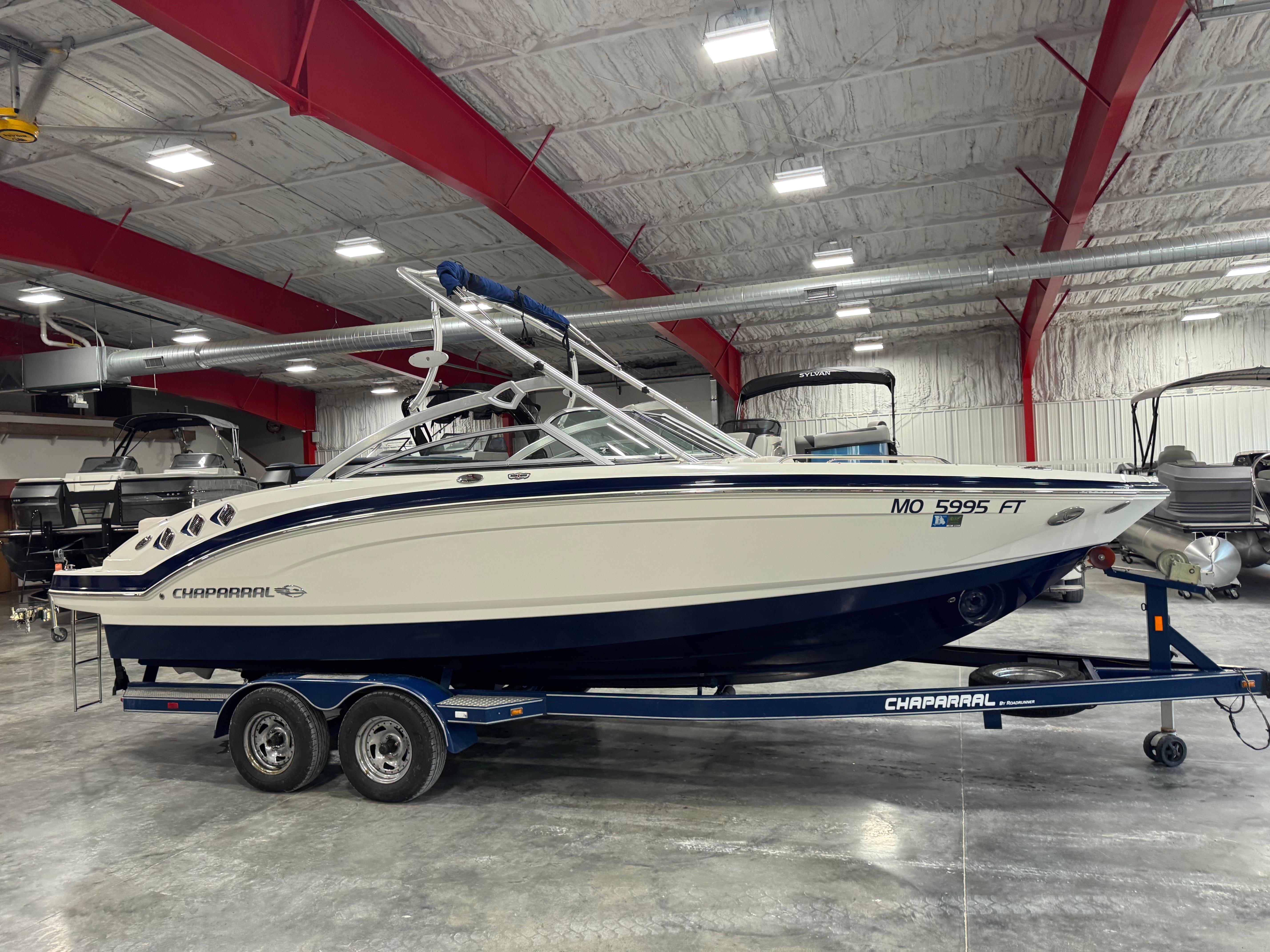 Chaparral 246 SSi 2011 Chaparral 246 SSi boat on trailer in indoor storage facility.