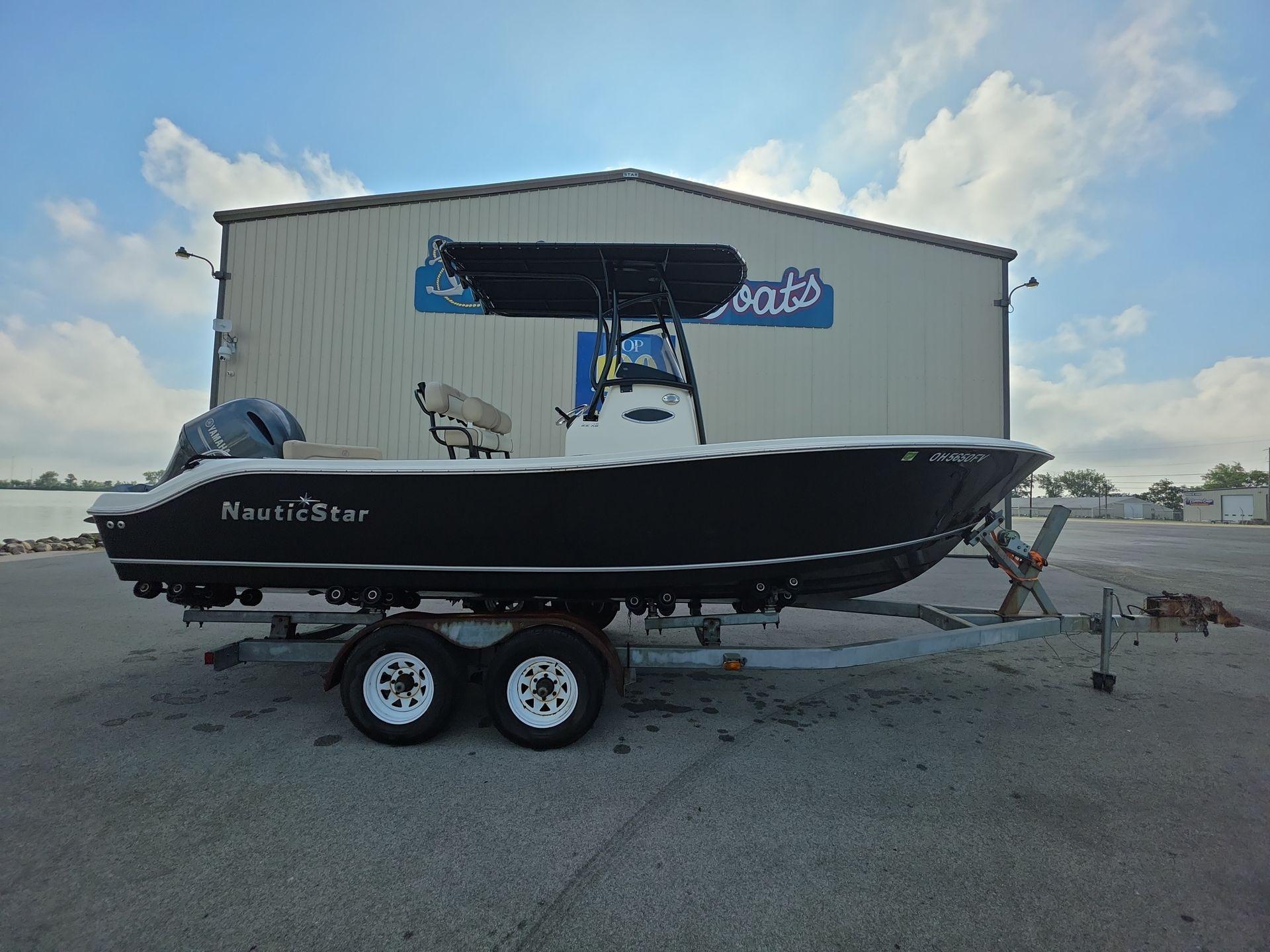 NauticStar 22 XS Offshore 2018 NauticStar 22 XS Offshore boat on trailer, parked near a building.