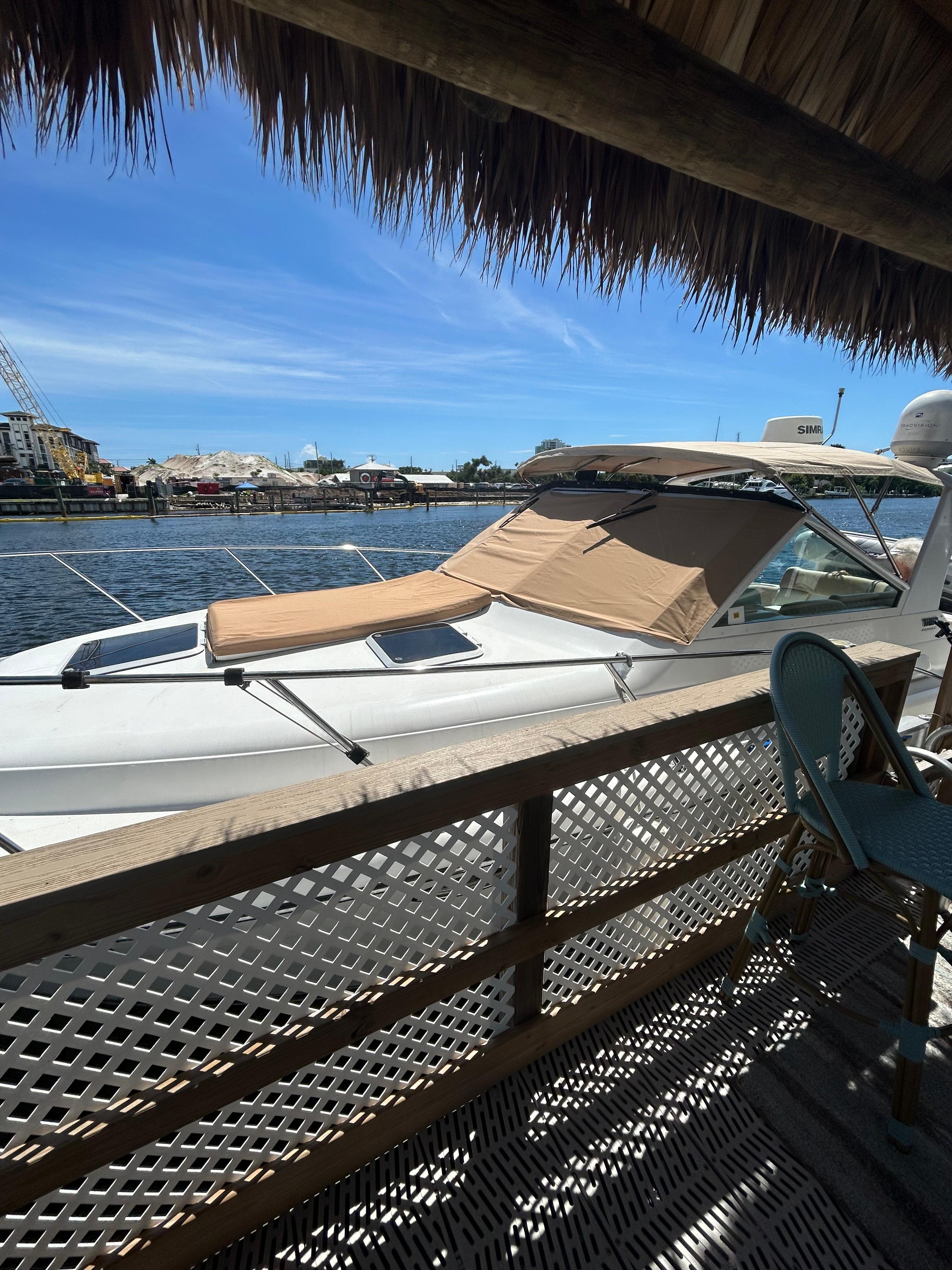 Tiara Yachts 3100 Open 2001 Tiara Yachts 3100 Open docked by a waterfront deck under a sunny sky.