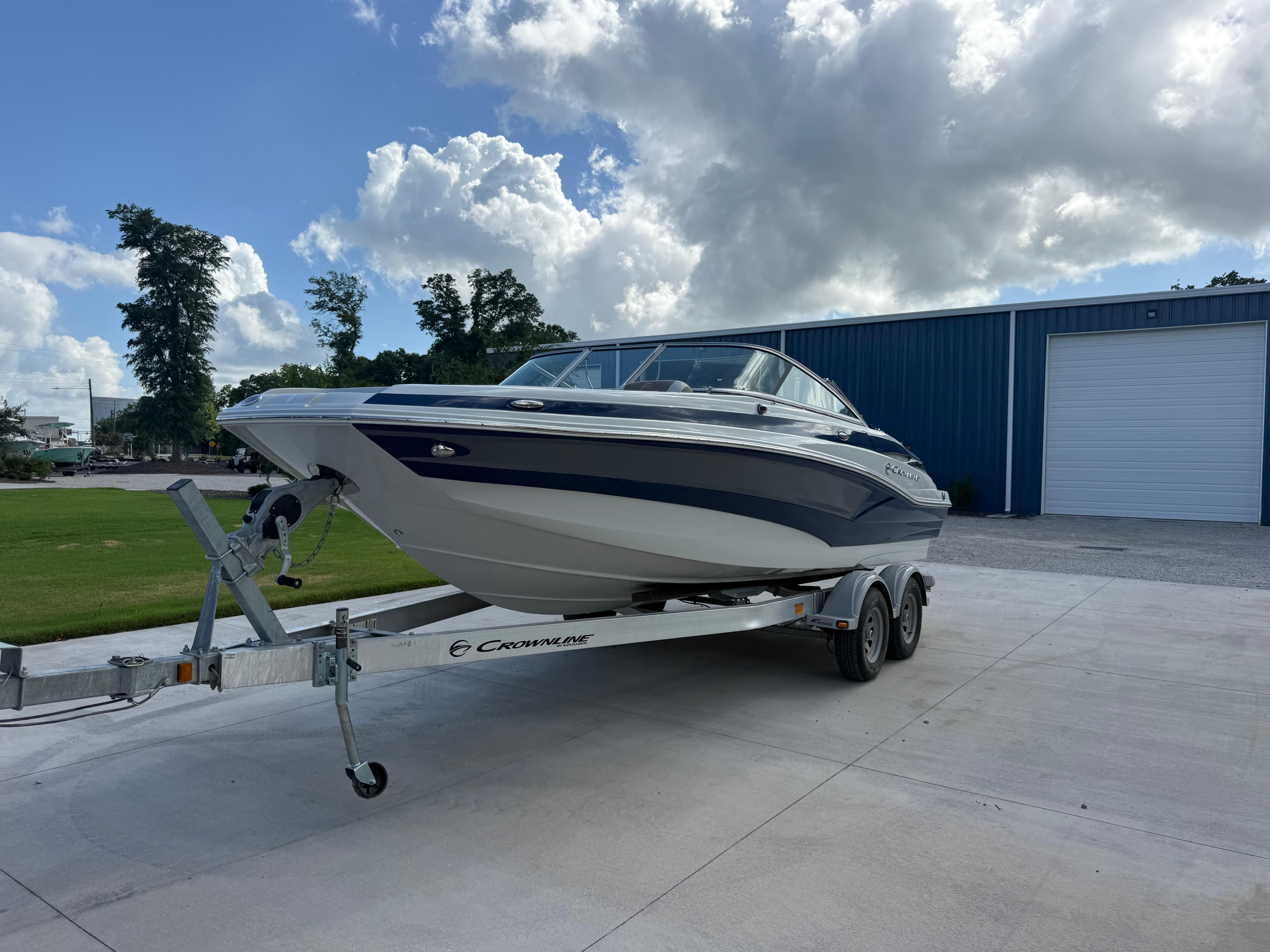 Crownline Eclipse E215 XS 2022 Crownline Eclipse E215 XS boat on trailer, parked outdoors.