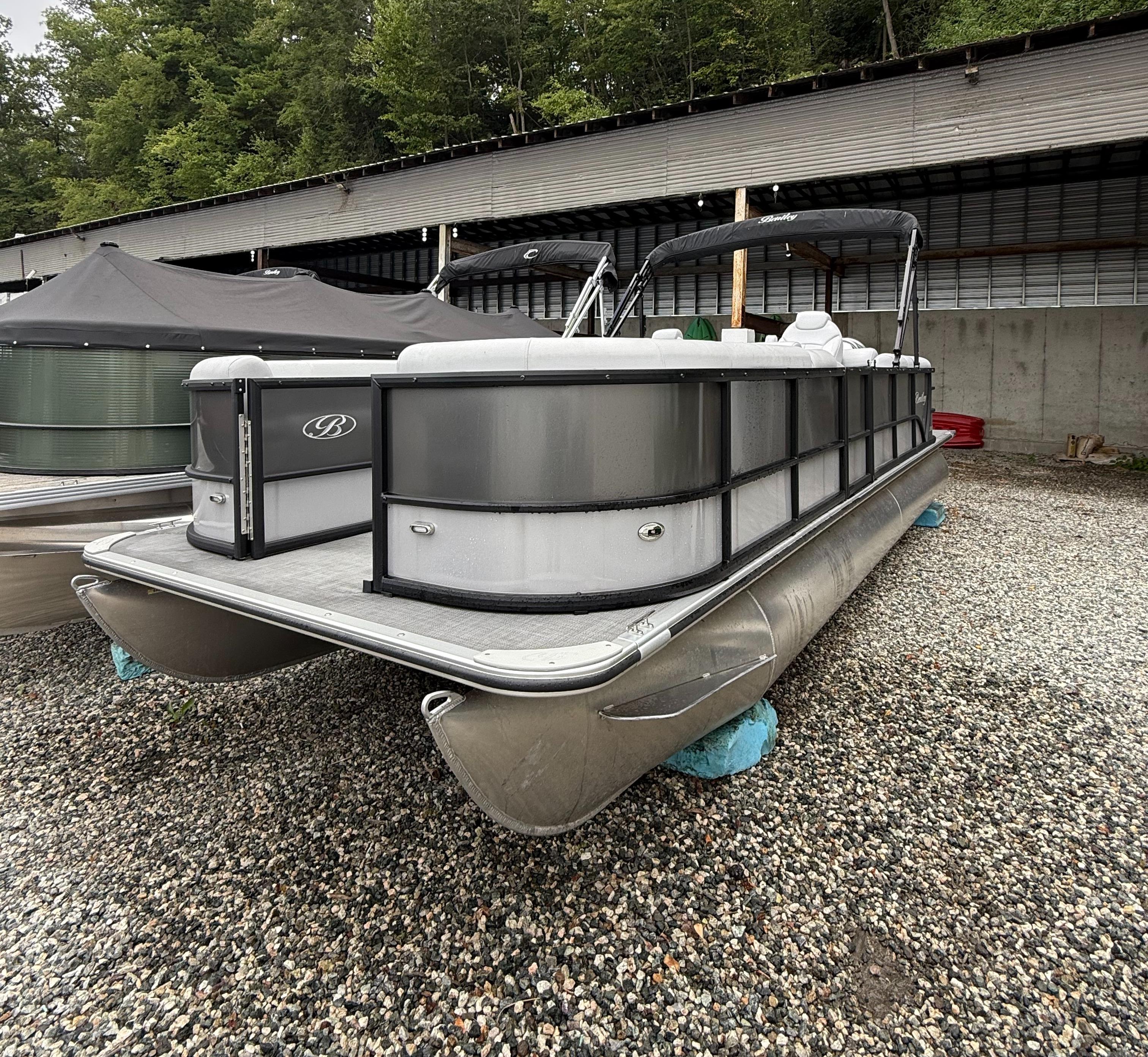 Bentley Pontoons 240 Navigator 2024 Bentley Pontoons 240 Navigator on gravel, under a covered area, with trees in the background.