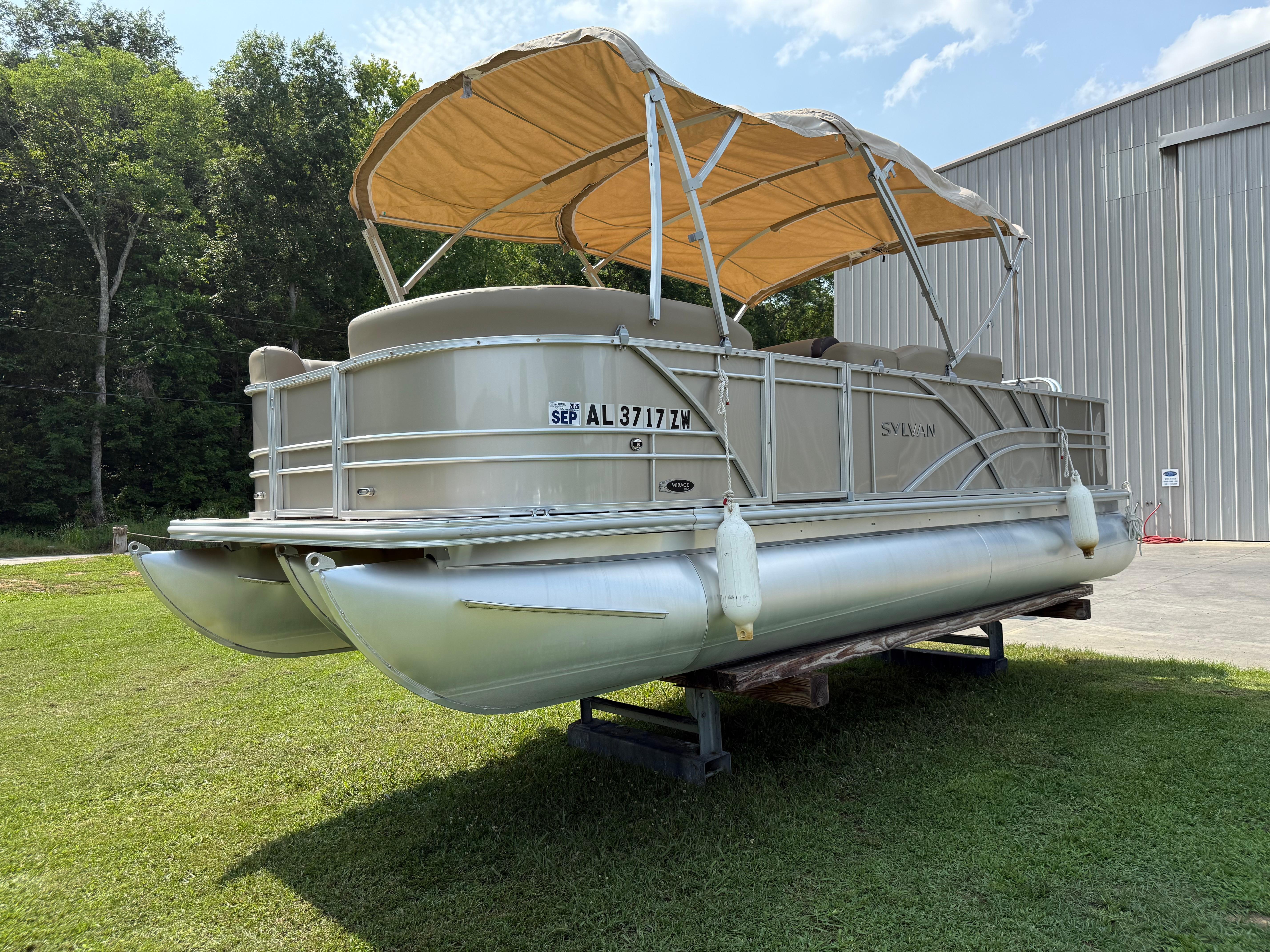 Sylvan Mirage 822 PARTY FISH 2021 Sylvan Mirage 822 PARTY FISH pontoon boat on grass near a building.