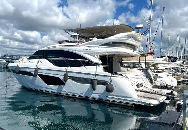 Princess F55 2019 Princess F55 yacht docked at marina under cloudy sky.