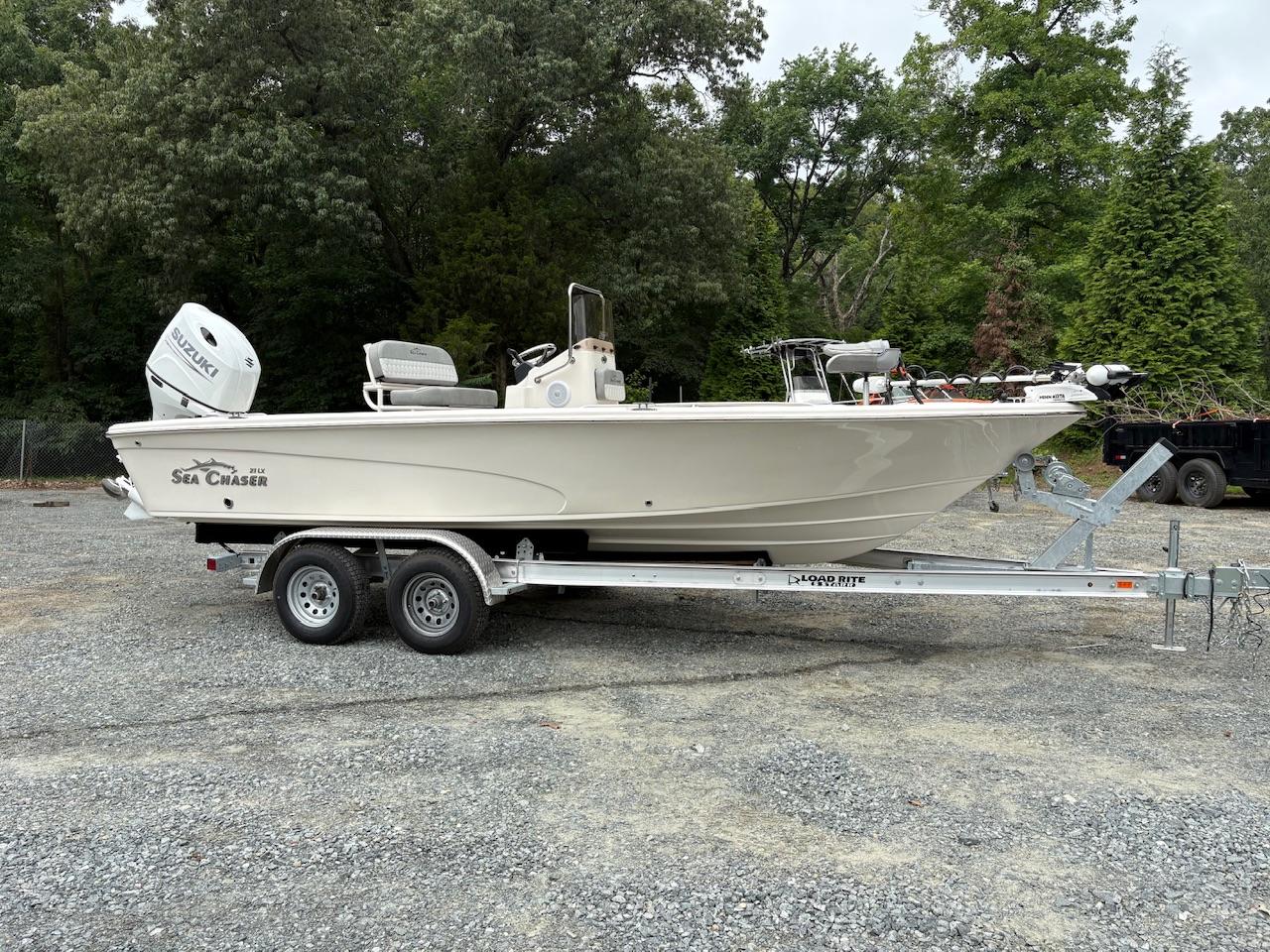 Sea Chaser 21 LX 2025 Sea Chaser 21 LX boat on trailer, parked outdoors with trees in background.