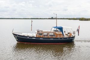 Custom Klaassen Kotter 1981 Klaassen Kotter 14.10 yacht cruising on calm waters under cloudy skies.