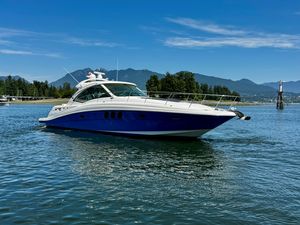 Sea Ray 48 Sundancer 2006 Sea Ray 48 Sundancer yacht cruising on a scenic lake with mountains in the background.