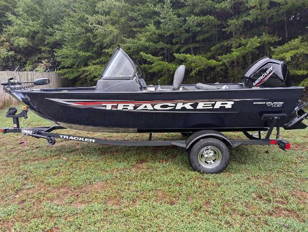 Tracker Pro Guide V-16 WT 2025 Tracker Pro Guide V-16 WT boat on trailer, parked on grass with trees in background.