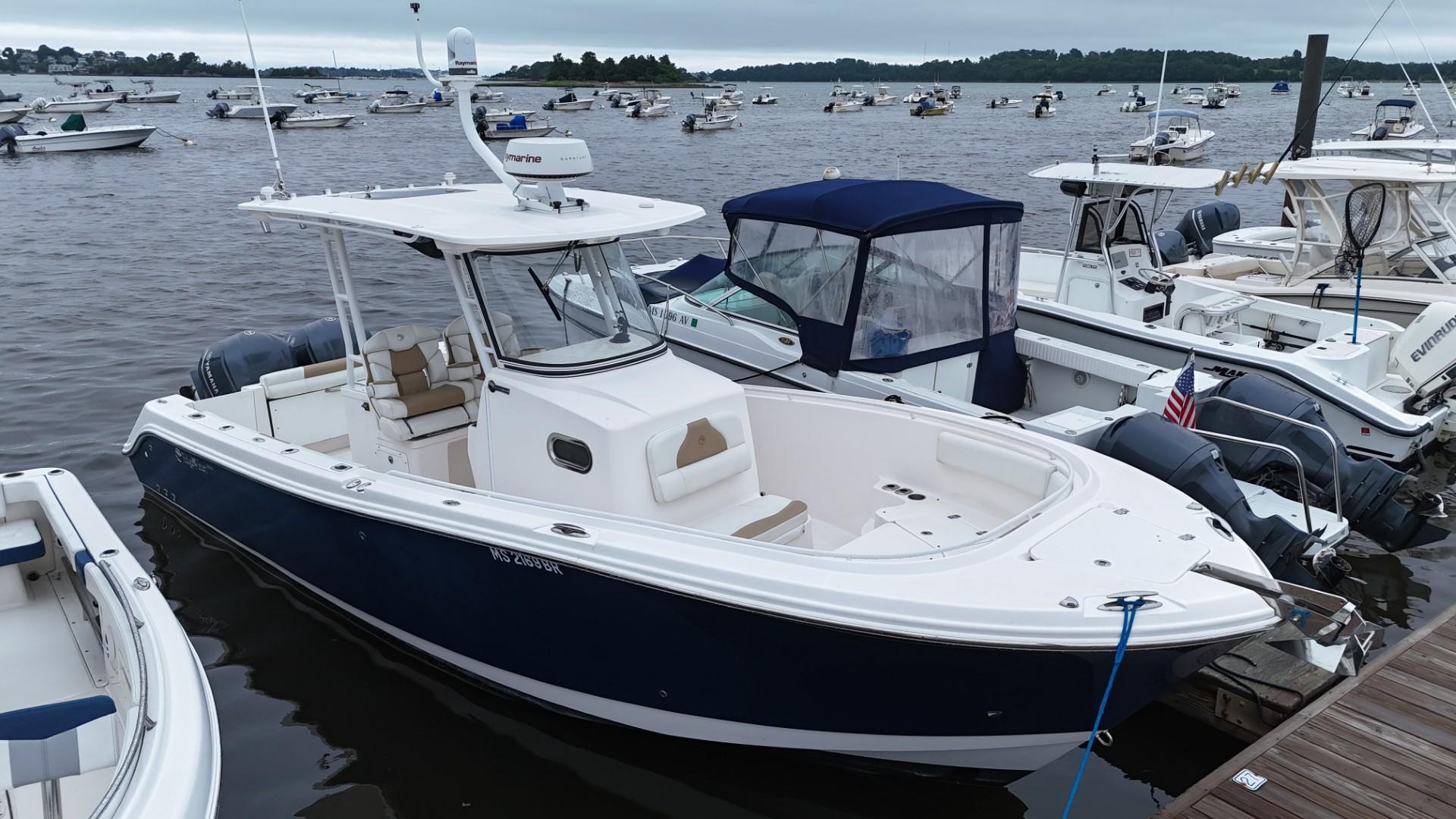 Edgewater 280CC 2015 Edgewater 280CC boat docked among other vessels on a cloudy day.