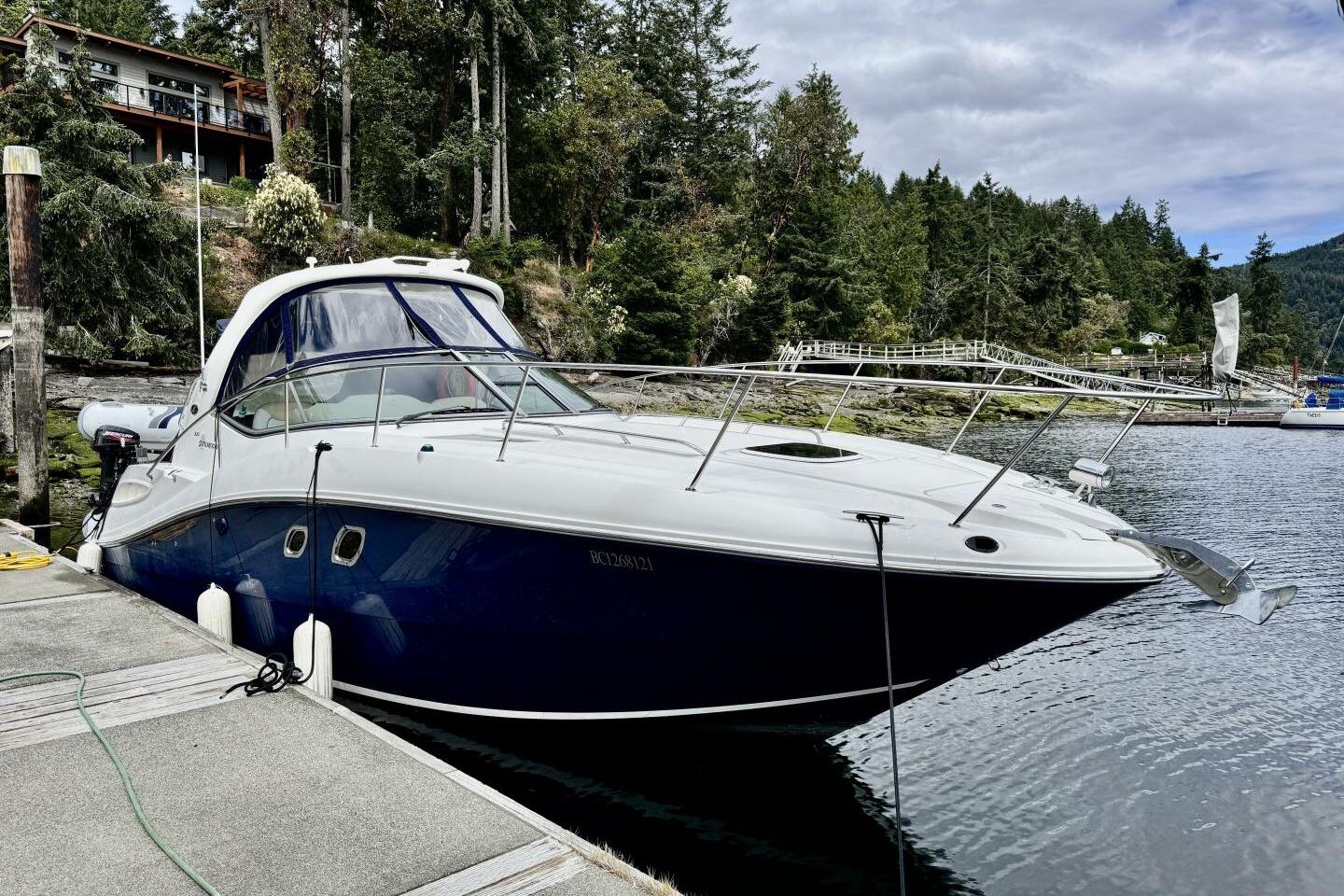 Sea Ray 330 Sundancer 2008 Sea Ray 330 Sundancer docked by a scenic forested shoreline.