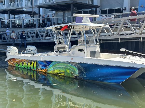 Twin Vee 26 GF 2017 Twin Vee 26 GF boat with vibrant Mahi Mahi artwork docked at a marina.
