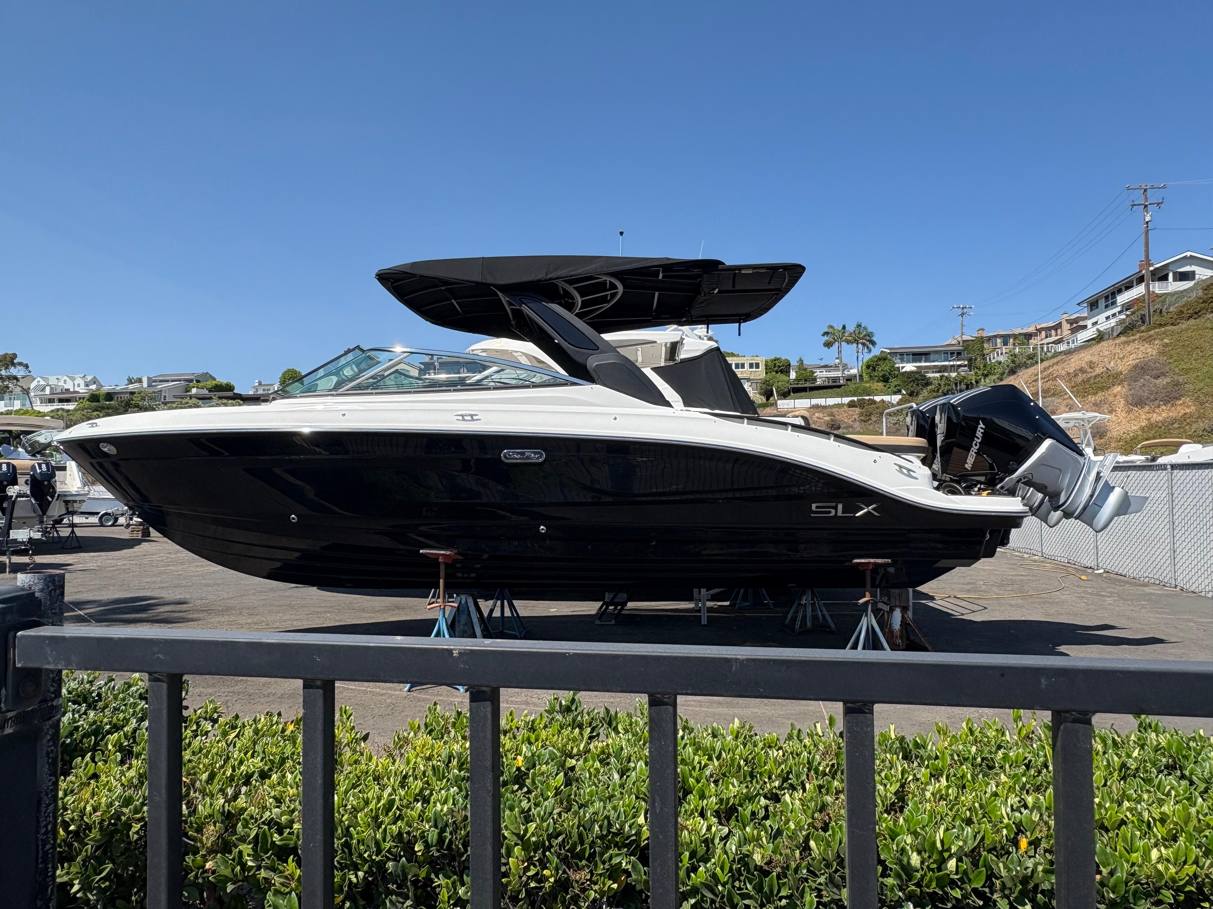 Sea Ray SLX 280 Outboard 2026 Sea Ray SLX 280 Outboard boat on display in a marina setting.