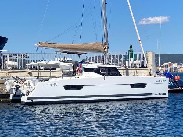 Fountaine Pajot Lucia 40 2017 Fountaine Pajot Lucia 40 catamaran docked at a marina under clear blue skies.