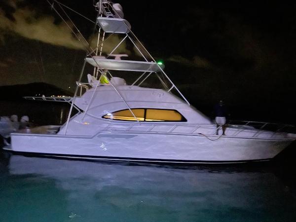 Bertram 510 Convertible 2002 Bertram 510 Convertible yacht illuminated at night on the water.