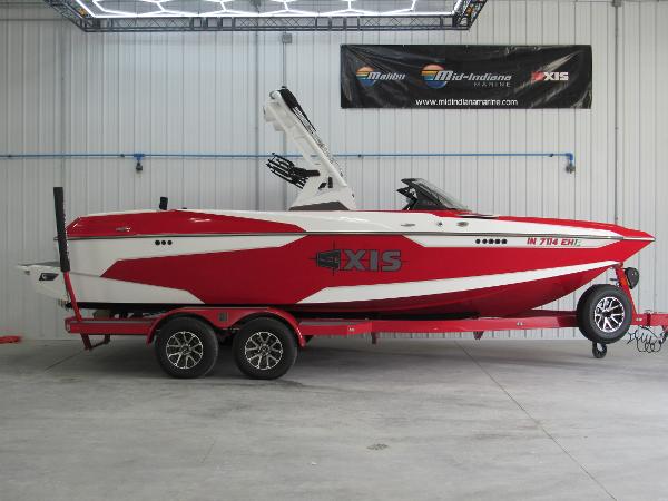 Axis A22 2022 Axis A22 red and white boat on trailer in showroom.