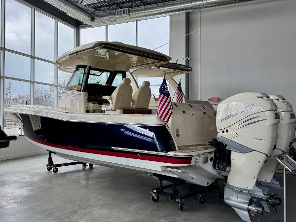 Chris-Craft Catalina 30 2022 Chris-Craft Catalina 30 boat with dual Mercury engines in a showroom.