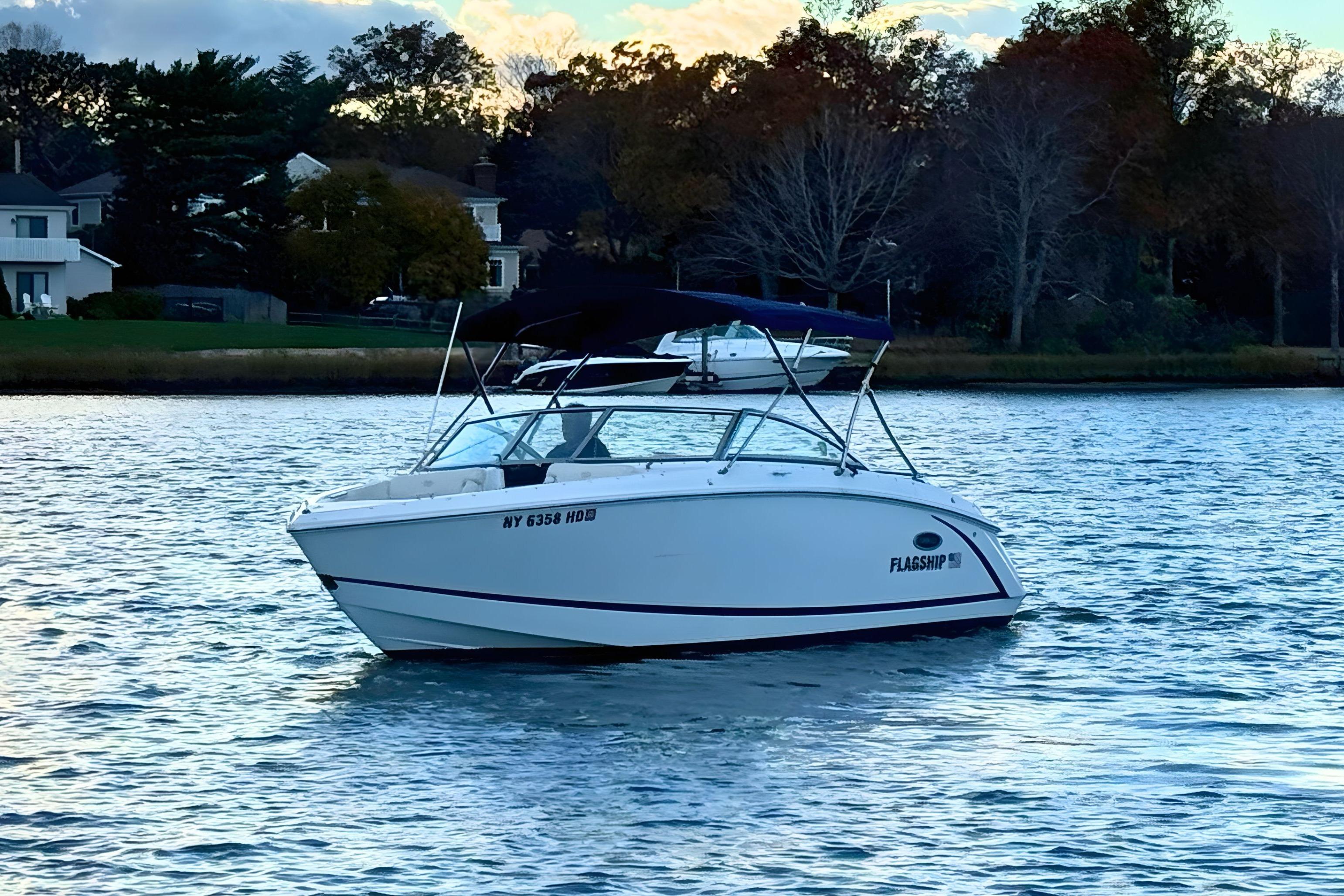 Cobalt R3 2019 Cobalt R3 boat on calm water near a wooded shoreline.