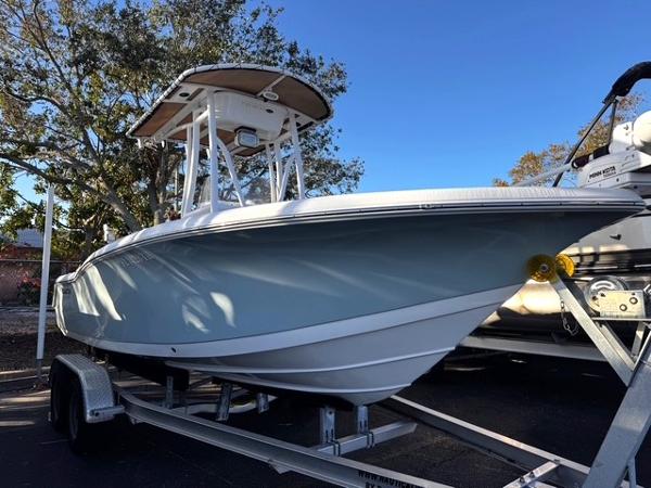 Tidewater 210 LXF 2022 Tidewater 210 LXF boat on trailer, parked outdoors under clear blue sky.