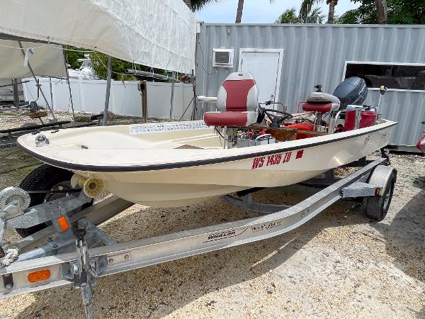 Boston Whaler 150 Sport 1976 Boston Whaler 150 Sport boat on trailer, parked outdoors near a storage unit.