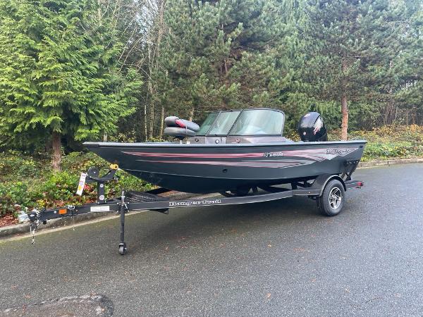 Ranger VS1682SC Reata 2024 Ranger VS1682SC Reata boat on trailer, parked on a forested road.