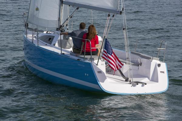 Catalina 275 Sport 2024 Catalina 275 Sport sailboat on water with two people and American flag.