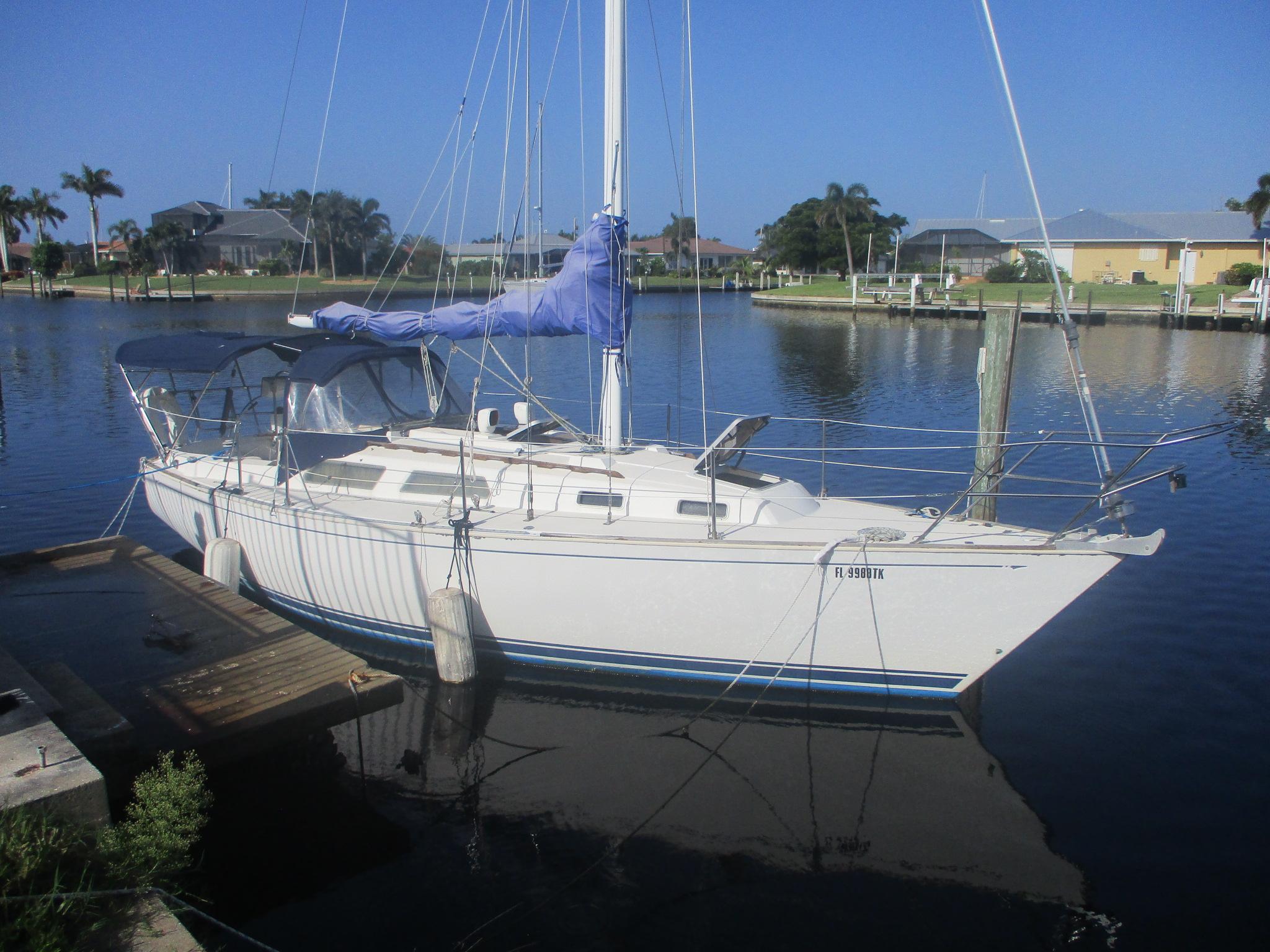Sabre 30 MKIII 1989 Sabre 30 MKIII sailboat docked in a serene marina setting.