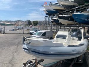 Lomac 710 IN 2016 Lomac 710 IN boat on trailer in marina storage area.