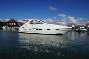 Sealine SC38 2009 Sealine SC38 yacht docked in a marina under a clear blue sky.