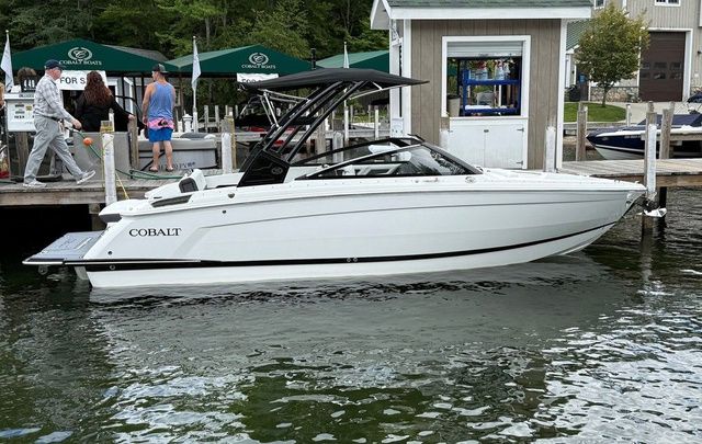 Cobalt R6 2025 Cobalt R6 boat docked at a marina with people nearby.