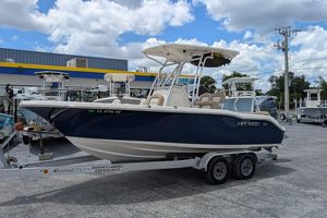 Key West 219 FS 2014 Key West 219 FS boat on trailer at dealership under blue sky.
