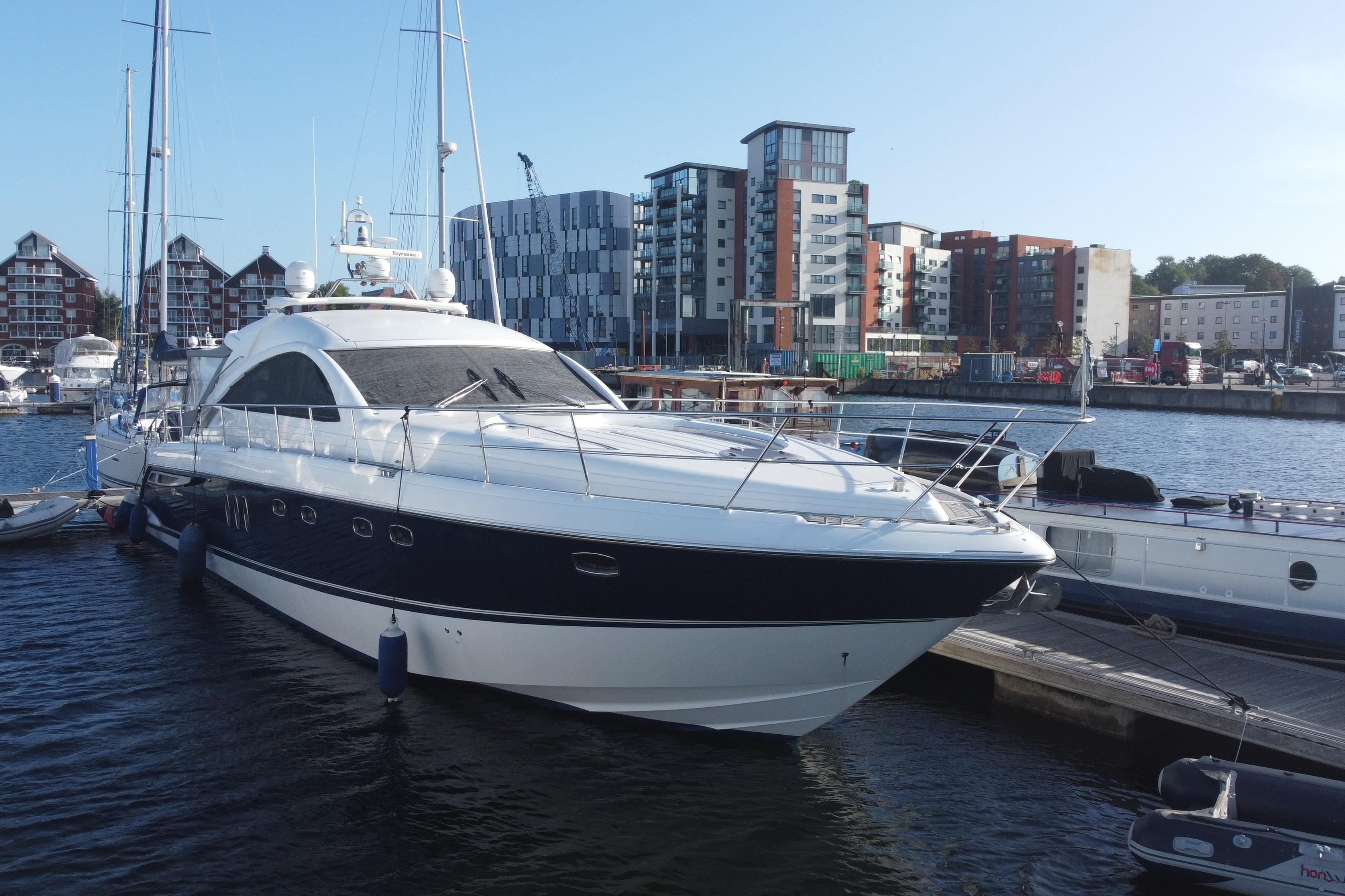 Fairline Targa 62 GT 2006 Fairline Targa 62 GT yacht docked in a marina with modern buildings in the background.