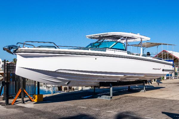 Axopar 37 Sun Top 2024 Axopar 37 Sun Top boat on display at a marina.