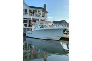 Sailfish 325 DC 2016 Sailfish 325 DC boat docked near waterfront buildings.