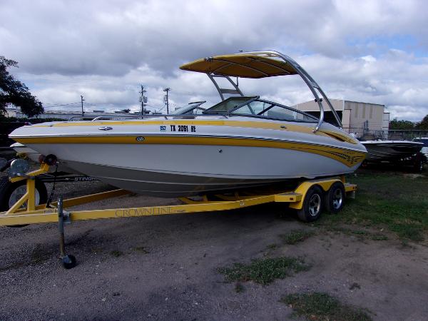 Crownline 23SS 2007 Crownline 23SS boat on trailer, yellow and white design, parked outdoors.