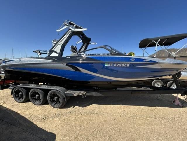 Centurion F125 2021 Centurion F125 boat with blue and silver design on a trailer.