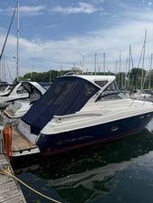 Regal 38 Express 2014 Regal 38 Express yacht docked at marina, featuring sleek design and blue canopy.