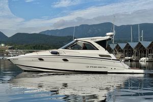 Regal 35 Sport Coupe 2013 Regal 35 Sport Coupe boat on calm water with scenic mountain backdrop.