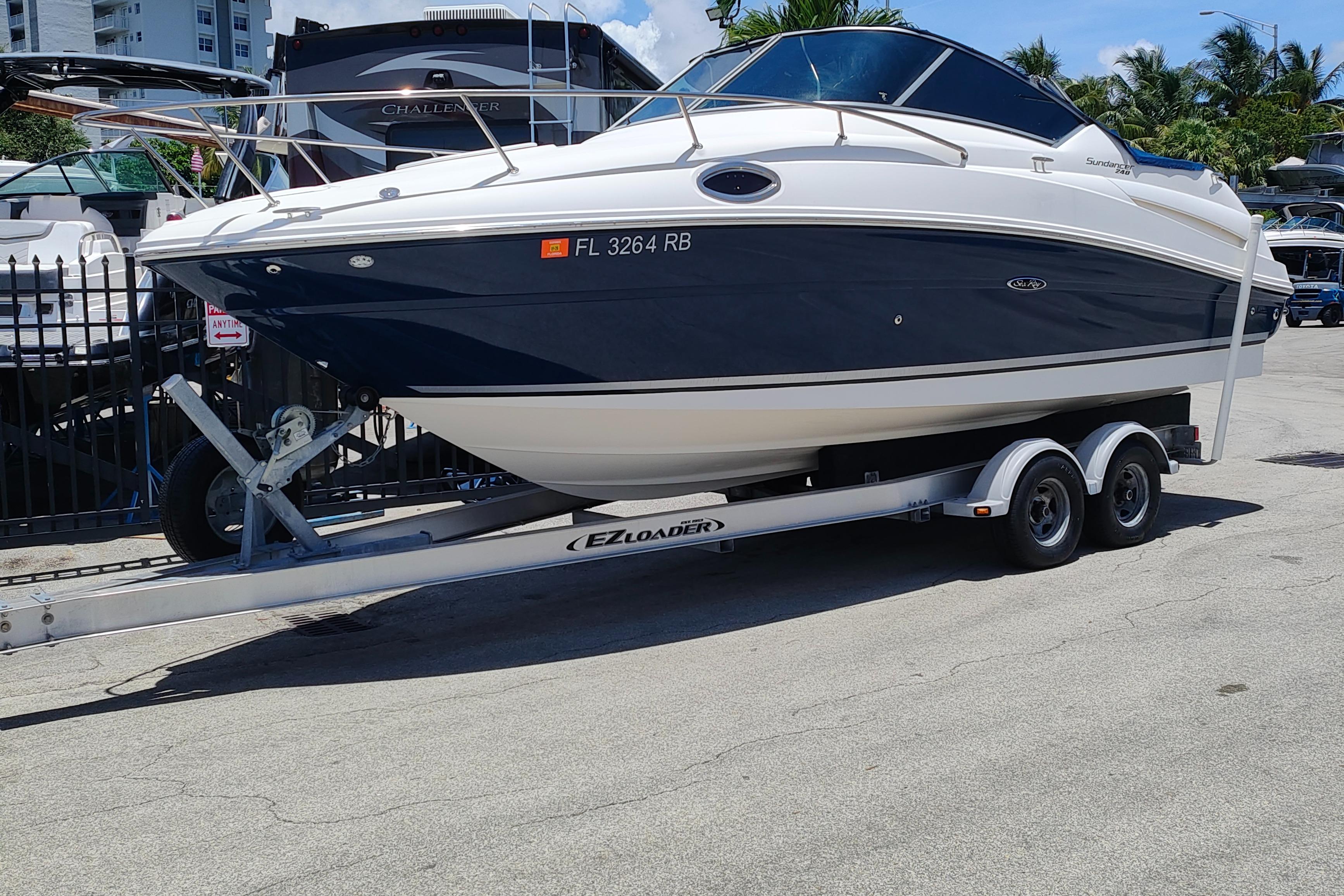 Sea Ray 240 Sundancer 2012 Sea Ray 240 Sundancer boat on trailer, parked outdoors.