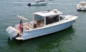 MJM 35z 2019 MJM 35z boat on water, featuring sleek design and American flag.