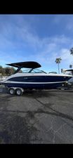 Sea Ray SLX 260 2026 Sea Ray SLX 260 boat on trailer, parked outdoors under blue sky.