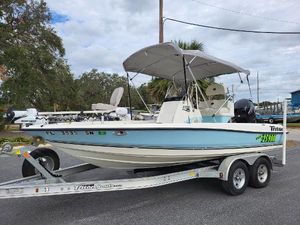 Triton 190 LTS 2006 Triton 190 LTS boat on trailer with canopy, parked outdoors.