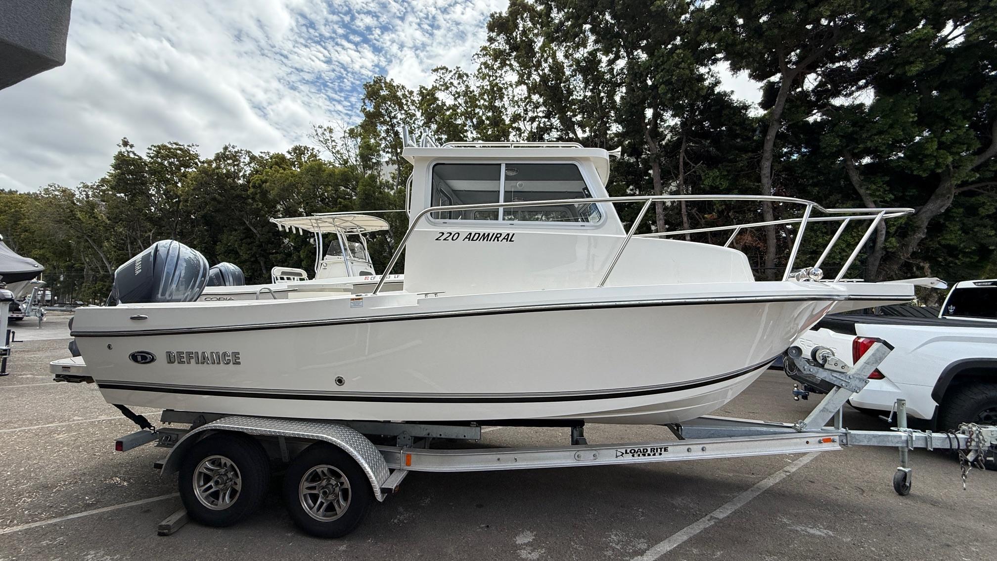 Defiance Admiral 220 EX 2025 Defiance Admiral 220 EX boat on trailer, parked outdoors.