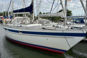 Trintella 38 1978 Trintella 38 sailboat docked in a marina, featuring blue and white hull.